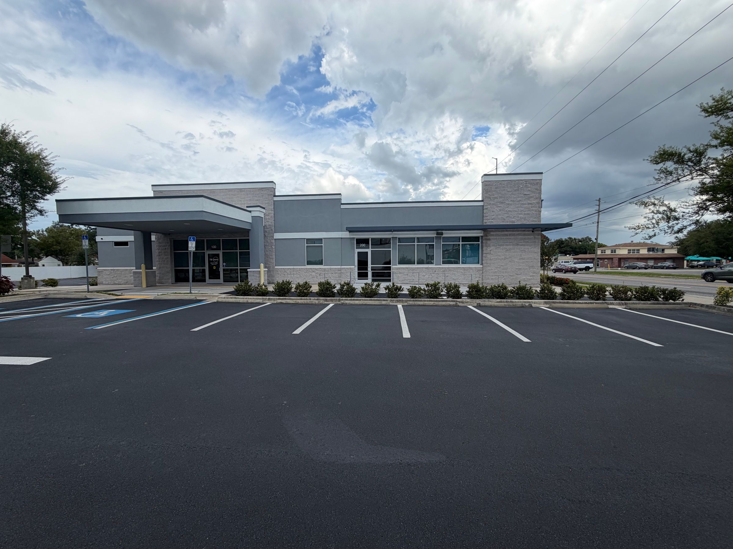 Wide view of the building across the freshly striped on-site parking lot